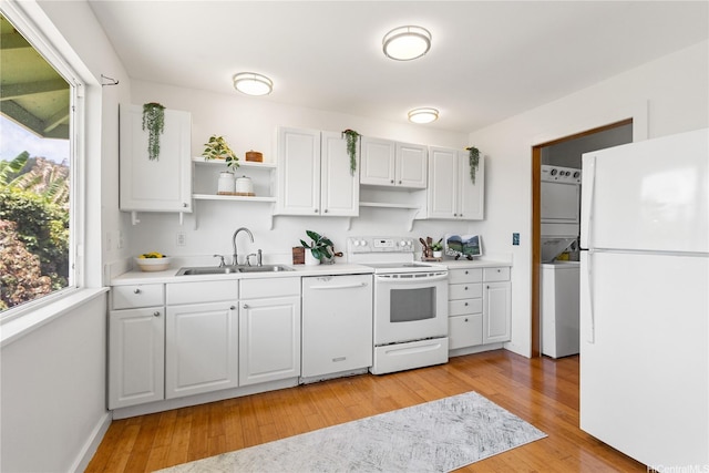 54-18 Haukoi Pl, Hauula, HI 96717 - kitchen featuring white appliances, stacked washing machine and dryer, open shelves, light wood-type flooring, and light countertops