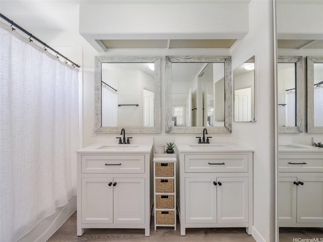94-1157 Kaloli Loop, Waipahu, HI 96797 - bathroom with two vanities, shower / bathtub combination with curtain, and wood finished floors