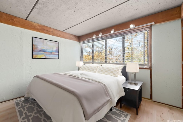 98-310 Kamehameha Hwy Unit 224, Aiea, HI 96701 - bedroom with light wood-style flooring and a textured wall
