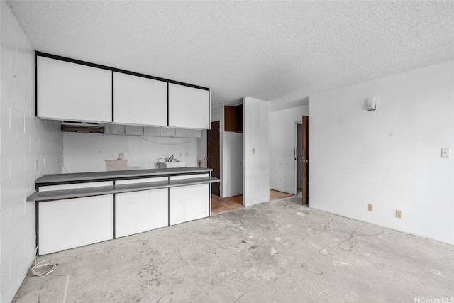 1687 Pensacola St Unit 1004, Honolulu, HI 96822 - kitchen with white cabinetry and a textured ceiling