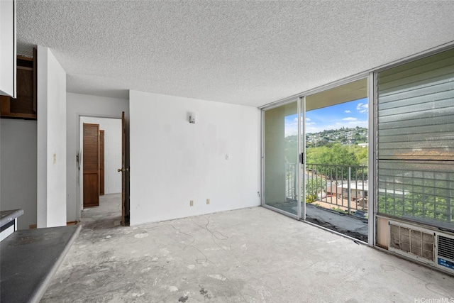 1687 Pensacola St Unit 1004, Honolulu, HI 96822 - spare room with floor to ceiling windows and a textured ceiling