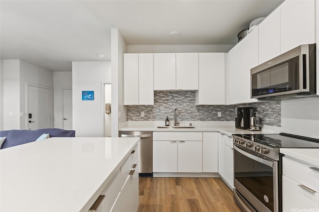 91-1640 Honouliuli St Unit 82, Ewa Beach, HI 96706 - kitchen featuring stainless steel appliances, light countertops, light wood-style flooring, and decorative backsplash