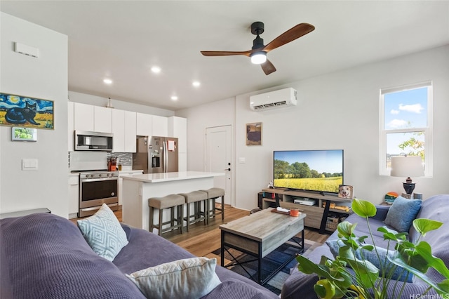 91-1640 Honouliuli St Unit 82, Ewa Beach, HI 96706 - living room with an AC wall unit, light wood-style floors, a ceiling fan, and recessed lighting