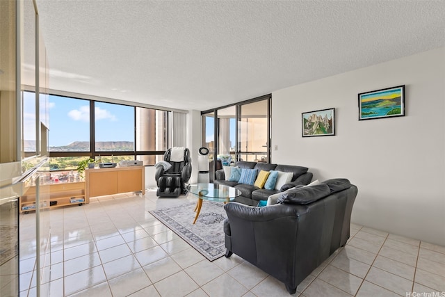 2499 Kapiolani Blvd Unit 2109, Honolulu, HI 96826 - living area featuring floor to ceiling windows, a mountain view, light tile patterned flooring, and a textured ceiling