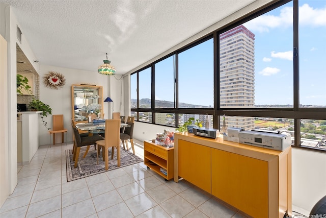 2499 Kapiolani Blvd Unit 2109, Honolulu, HI 96826 - dining space featuring light tile patterned floors, a textured ceiling, and a mountain view