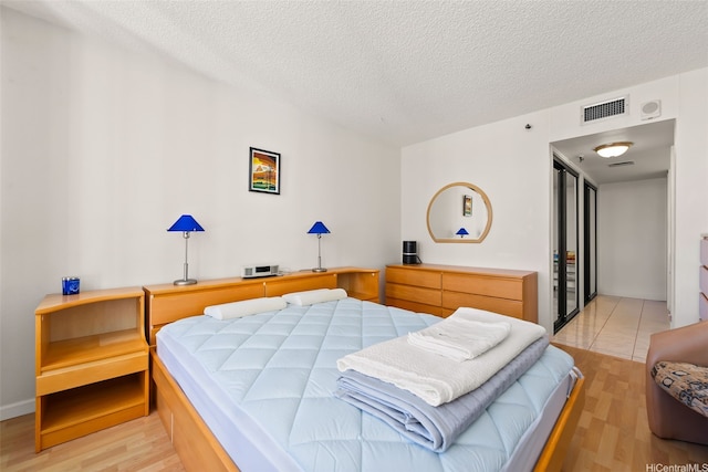 2499 Kapiolani Blvd Unit 2109, Honolulu, HI 96826 - bedroom featuring light wood finished floors and a textured ceiling