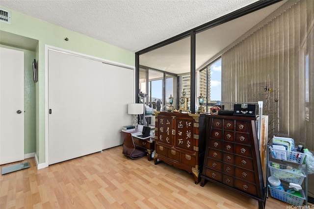 2499 Kapiolani Blvd Unit 2109, Honolulu, HI 96826 - bedroom featuring wood finished floors, a closet, and a textured ceiling