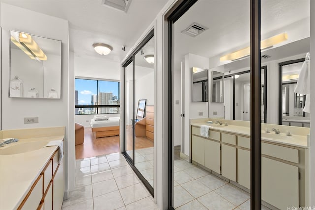 2499 Kapiolani Blvd Unit 2109, Honolulu, HI 96826 - ensuite bathroom featuring two vanities, tile patterned floors, and a city view