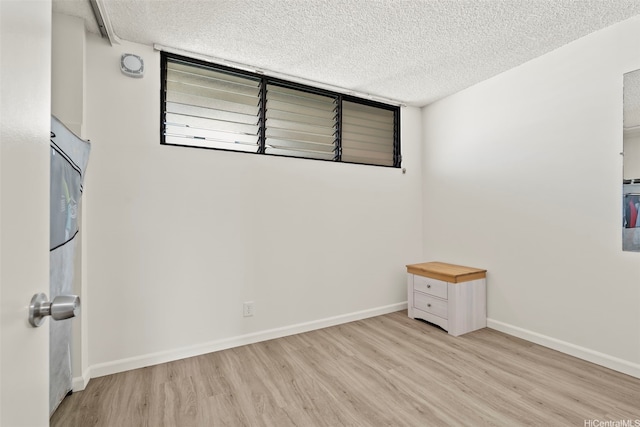 2121 Ala Wai Blvd Unit 1902, Honolulu, HI 96815 - empty room with wood finished floors and a textured ceiling