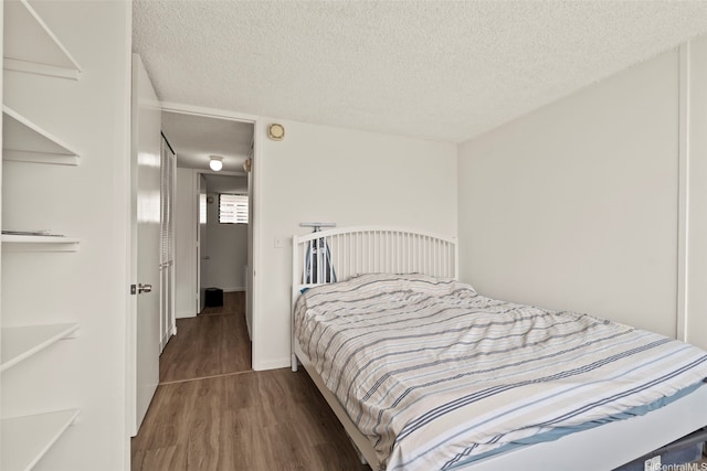 2121 Ala Wai Blvd Unit 1902, Honolulu, HI 96815 - bedroom with wood finished floors and a textured ceiling