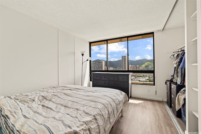 2121 Ala Wai Blvd Unit 1902, Honolulu, HI 96815 - bedroom featuring wood finished floors, a view of city, and a textured ceiling