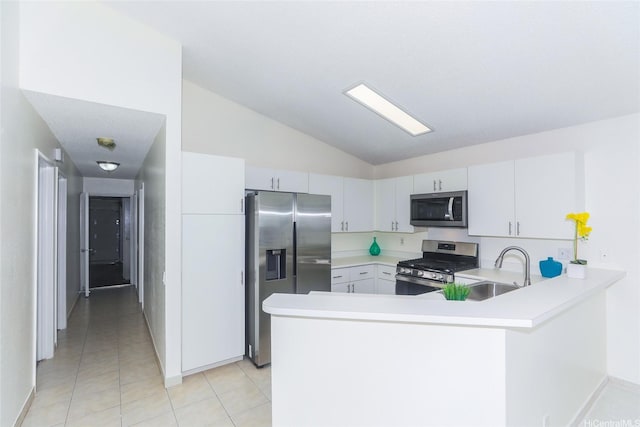 91-196 Wailohia Pl, Ewa Beach, HI 96706 - kitchen with appliances with stainless steel finishes, vaulted ceiling, light countertops, a peninsula, and light tile patterned flooring