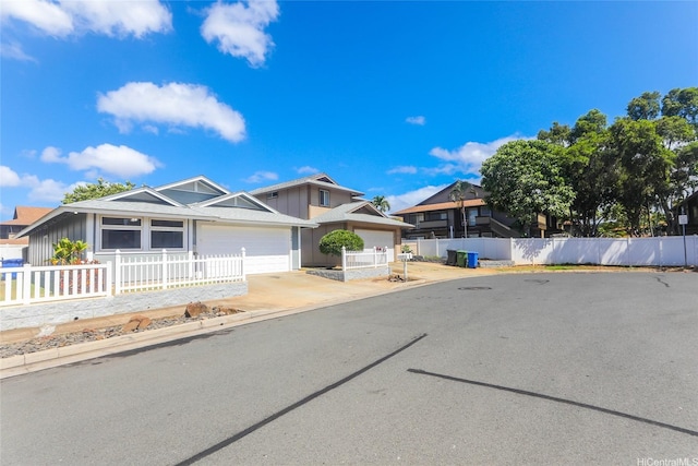 91-196 Wailohia Pl, Ewa Beach, HI 96706 - view of front of home featuring a garage, driveway, and board and batten siding