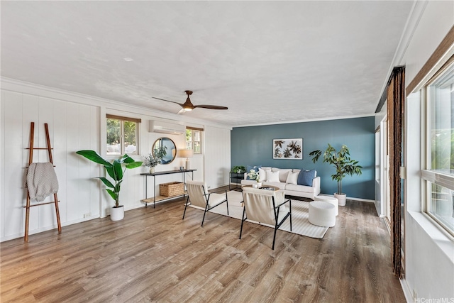 92-434 Kaiaulu St, Kapolei, HI 96707 - living area featuring wood finished floors, a wall mounted air conditioner, ornamental molding, and ceiling fan