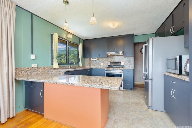 4692 Likini St, Honolulu, HI 96818 - kitchen with under cabinet range hood, stainless steel appliances, a peninsula, light stone countertops, and a textured ceiling