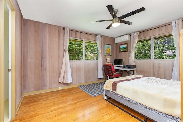 4692 Likini St, Honolulu, HI 96818 - bedroom with an AC wall unit, wood finished floors, wooden walls, and ceiling fan