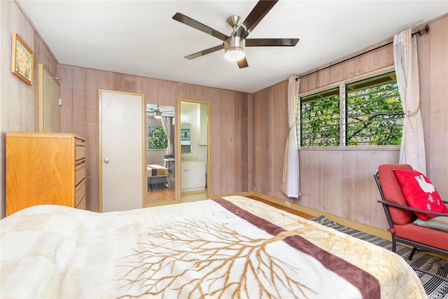 4692 Likini St, Honolulu, HI 96818 - bedroom featuring wood walls and a ceiling fan