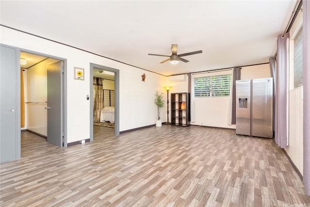 4692 Likini St, Honolulu, HI 96818 - unfurnished living room with light wood finished floors, a ceiling fan, and a wall mounted AC