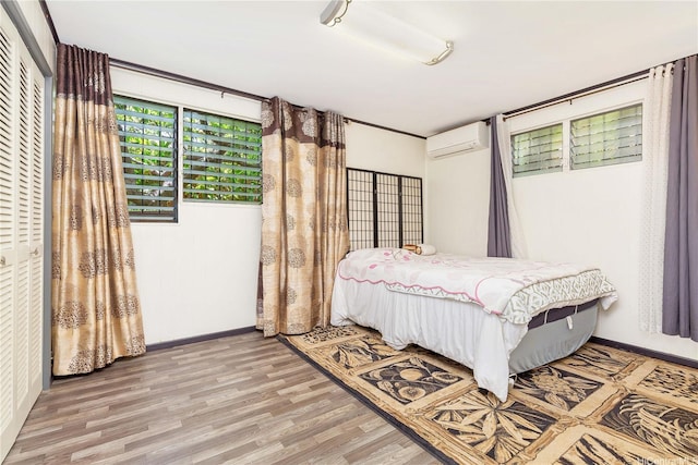 4692 Likini St, Honolulu, HI 96818 - bedroom featuring an AC wall unit and wood finished floors