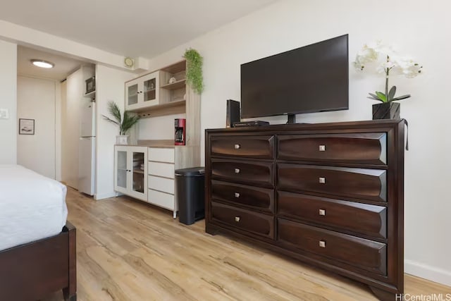 445 Seaside Ave Unit 3316, Honolulu, HI 96815 - bedroom featuring freestanding refrigerator and light wood-type flooring