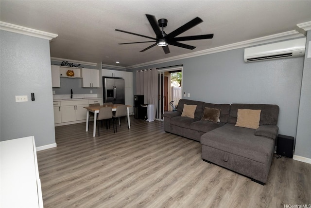 91-1097 Namahoe St Unit 4D, Kapolei, HI 96707 - living room with an AC wall unit, ornamental molding, ceiling fan, and light wood-style flooring