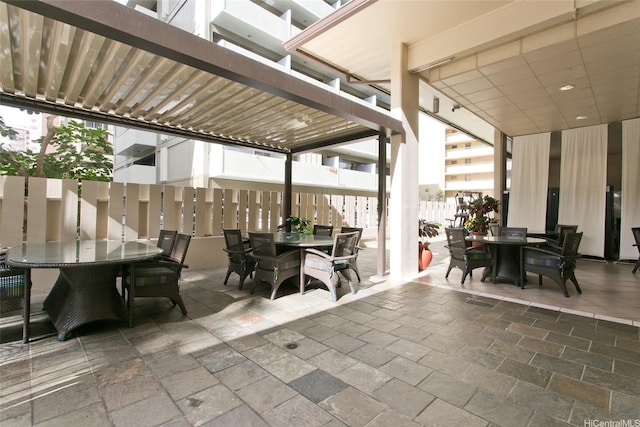 444 Kanekapolei St Unit 705, Honolulu, HI 96815 - view of patio featuring outdoor dining area and a pergola