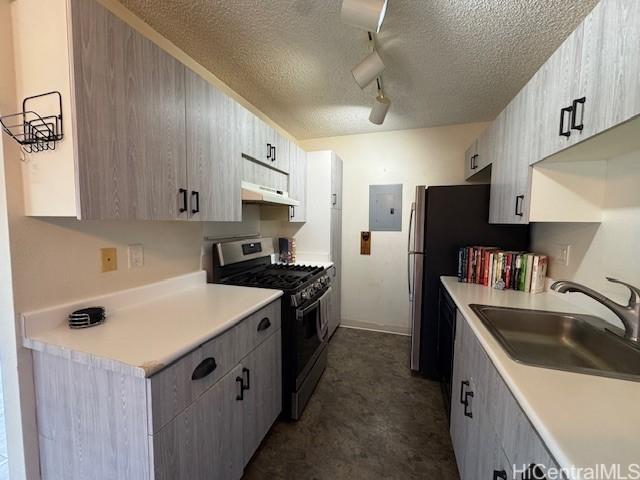91-1024 Mikohu St Unit 23B, Ewa Beach, HI 96706 - kitchen featuring stainless steel gas range, electric panel, a textured ceiling, light countertops, and under cabinet range hood