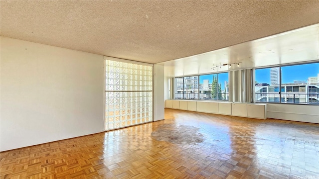 1310 Heulu St Unit 301, Honolulu, HI 96822 - spare room featuring track lighting, a textured ceiling, and a city view