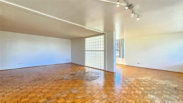 1310 Heulu St Unit 301, Honolulu, HI 96822 - unfurnished room with rail lighting and a wall of windows