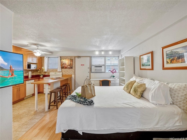 417 Nohonani St Unit 312, Honolulu, HI 96815 - bedroom featuring a textured ceiling, light wood-style flooring, and cooling unit