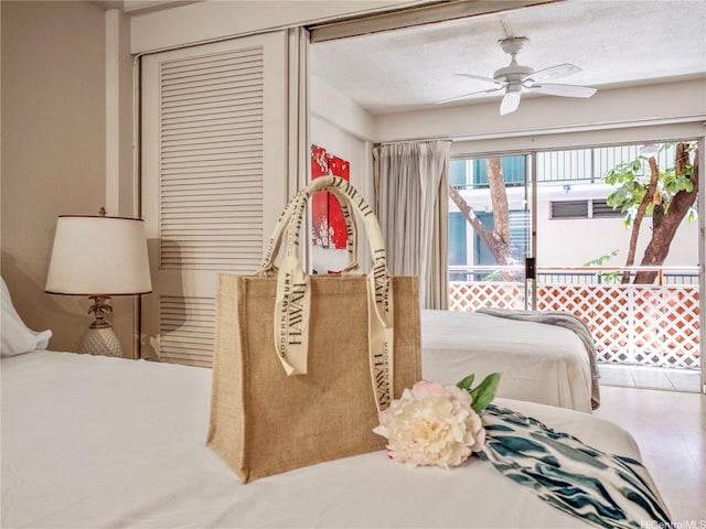 417 Nohonani St Unit 312, Honolulu, HI 96815 - bedroom featuring a textured ceiling, ceiling fan, and a closet