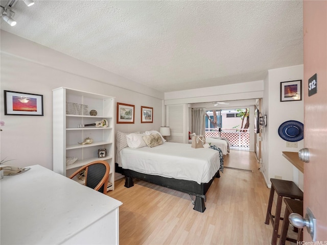 417 Nohonani St Unit 312, Honolulu, HI 96815 - bedroom with a textured ceiling and light wood finished floors