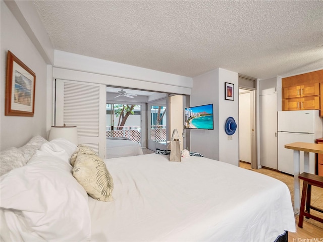 417 Nohonani St Unit 312, Honolulu, HI 96815 - bedroom with freestanding refrigerator, access to exterior, and a textured ceiling