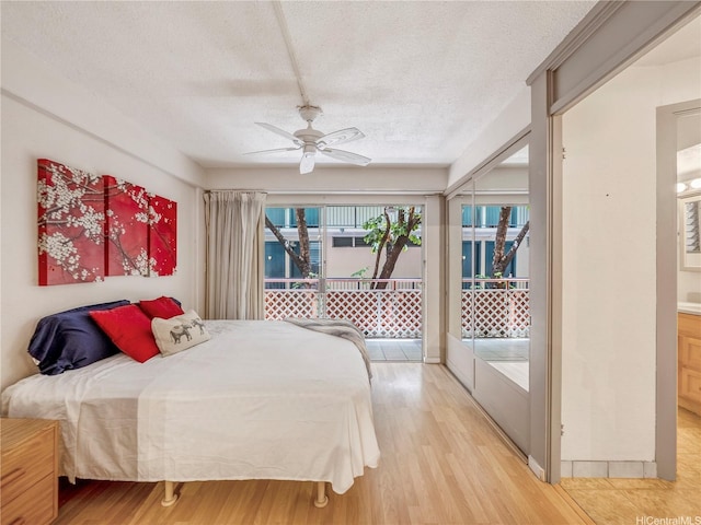 417 Nohonani St Unit 312, Honolulu, HI 96815 - bedroom featuring a textured ceiling, access to outside, light wood-style floors, a ceiling fan, and ensuite bathroom