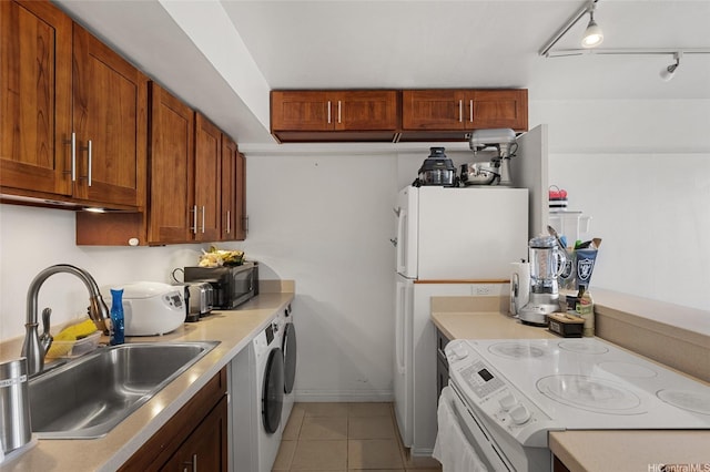 2333 Kapiolani Blvd Unit 3202, Honolulu, HI 96826 - kitchen featuring range, light countertops, light tile patterned flooring, washer / dryer, and brown cabinets