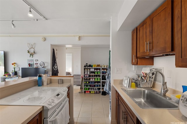 2333 Kapiolani Blvd Unit 3202, Honolulu, HI 96826 - kitchen with white electric range, light tile patterned flooring, light countertops, brown cabinetry, and rail lighting