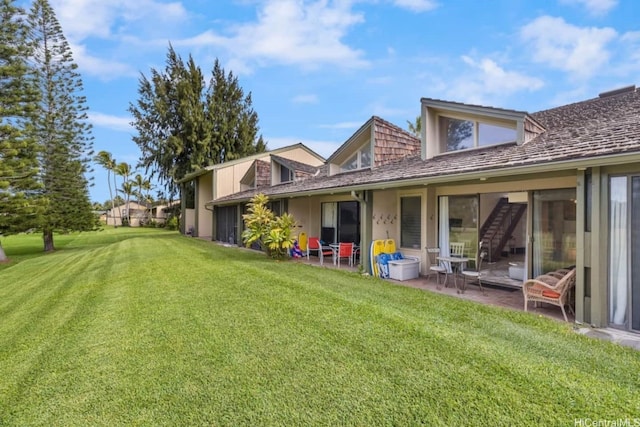 57-101 Kuilima Dr Unit 44, Kahuku, HI 96731 - rear view of house with a yard and a patio
