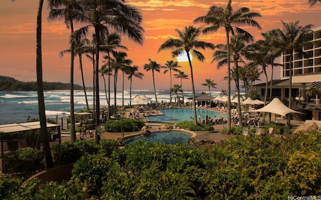 57-101 Kuilima Dr Unit 44, Kahuku, HI 96731 - pool at dusk featuring a community pool and a water view