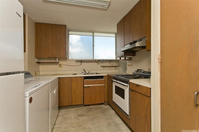 927 Prospect St Unit 606, Honolulu, HI 96822 - kitchen featuring under cabinet range hood, white electric stove, washer and dryer, light countertops, and a textured ceiling