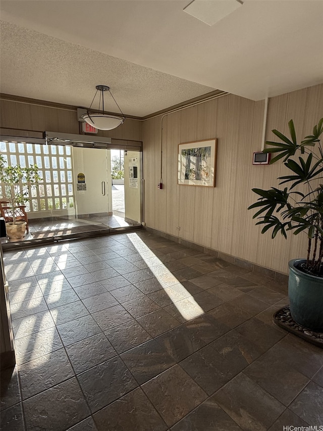 927 Prospect St Unit 606, Honolulu, HI 96822 - garage featuring baseboards and wood walls