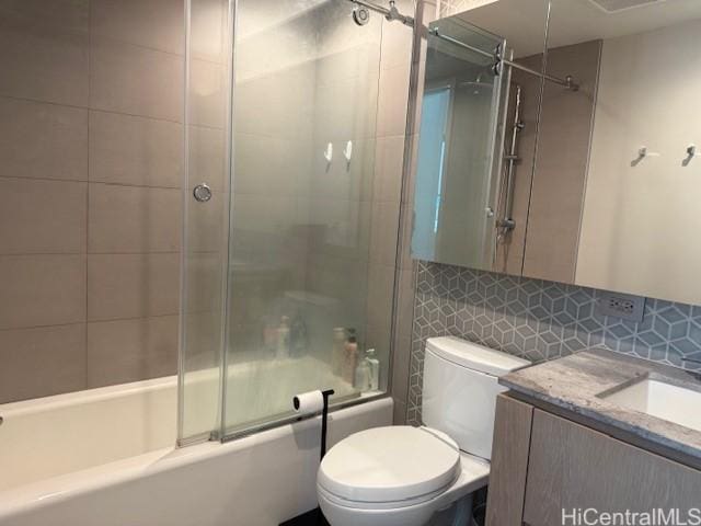 1000 Auahi St Unit 403, Honolulu, HI 96814 - full bathroom featuring shower / bath combination with glass door, vanity, decorative backsplash, and tile walls