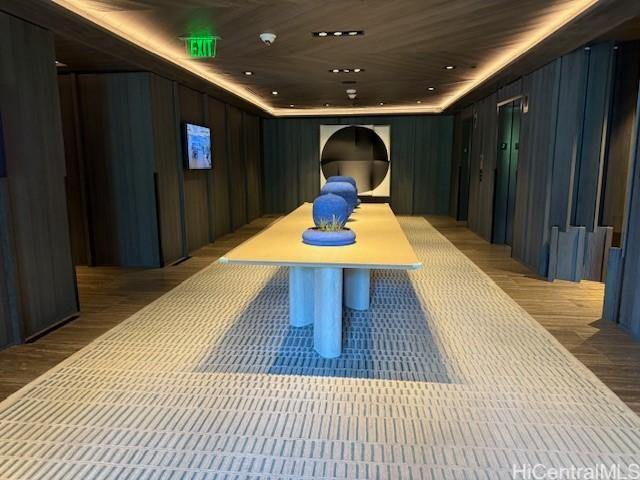 1000 Auahi St Unit 403, Honolulu, HI 96814 - interior space with wood walls and light wood-style floors