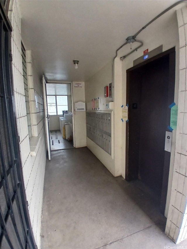 750 Kanoa St Unit 305, Honolulu, HI 96817 - hall featuring concrete flooring, elevator, and mail area