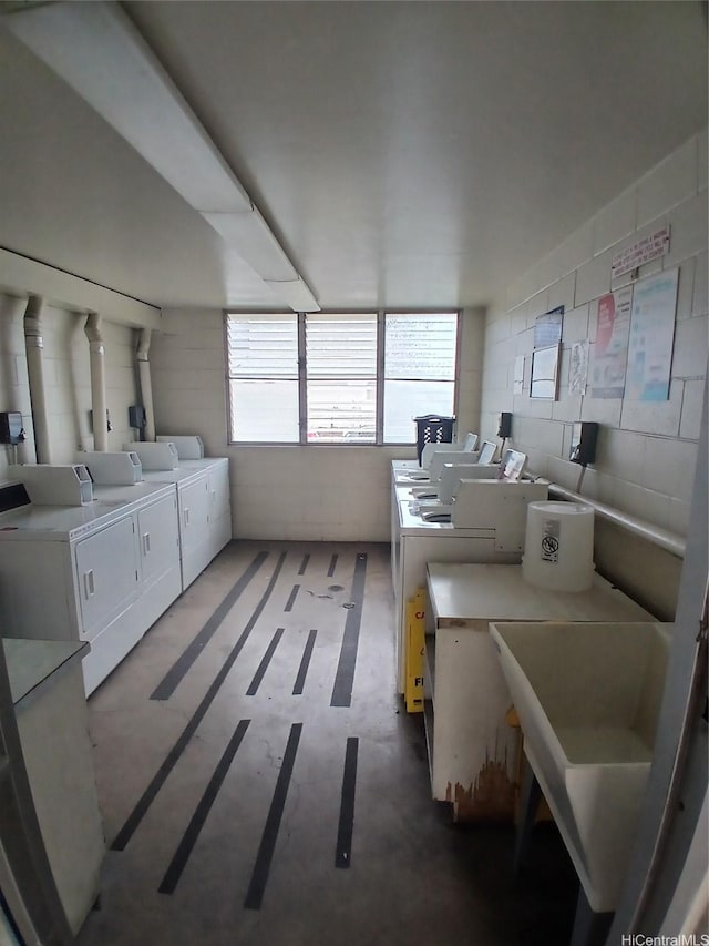 750 Kanoa St Unit 305, Honolulu, HI 96817 - communal laundry room with washer and clothes dryer and concrete block wall