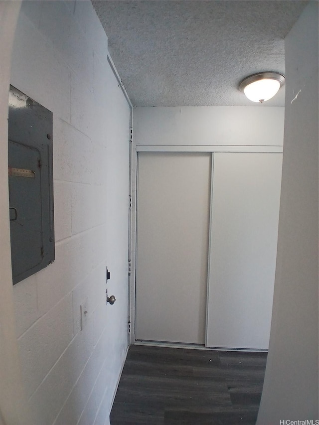 750 Kanoa St Unit 305, Honolulu, HI 96817 - corridor with a textured ceiling, electric panel, wood finished floors, and concrete block wall