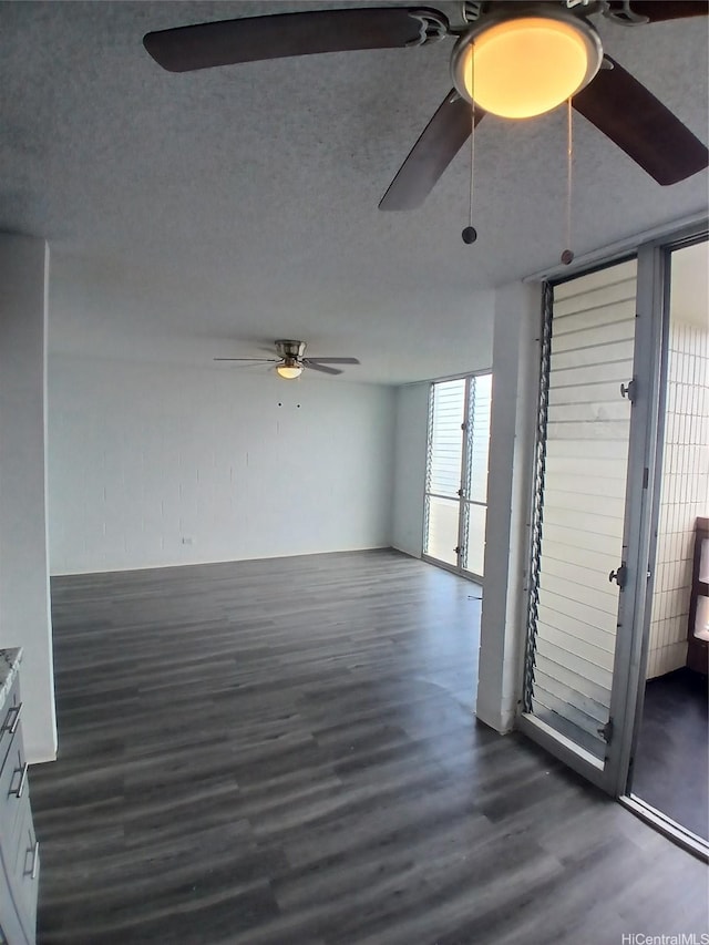 750 Kanoa St Unit 305, Honolulu, HI 96817 - spare room with ceiling fan, dark wood-style flooring, and a textured ceiling