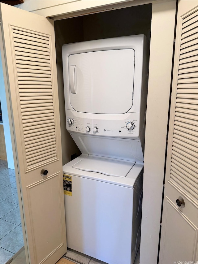 511 Hahaione St Unit 1-7C, Honolulu, HI 96825 - washroom with stacked washer / dryer and light tile patterned flooring