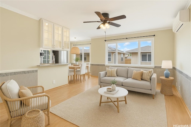 91-1026B Hoomaka St Unit 35, Ewa Beach, HI 96706 - living area featuring light wood finished floors, ornamental molding, a wall mounted AC, a wainscoted wall, and a ceiling fan