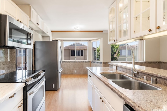 91-1026B Hoomaka St Unit 35, Ewa Beach, HI 96706 - kitchen with stainless steel appliances, light wood-type flooring, white cabinets, light stone counters, and glass insert cabinets