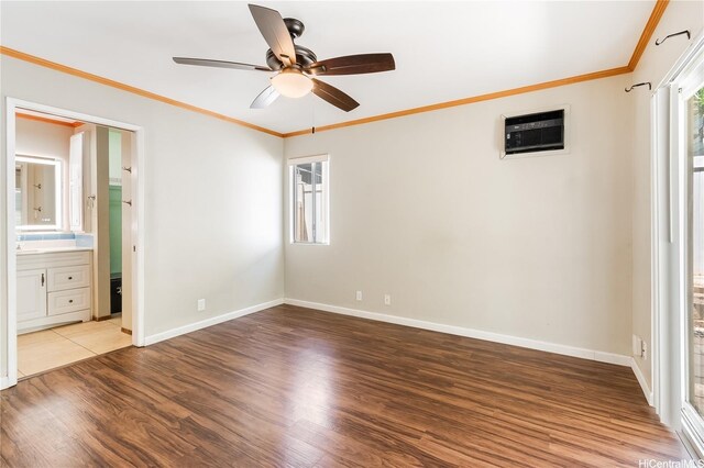 91-1026B Hoomaka St Unit 35, Ewa Beach, HI 96706 - unfurnished bedroom featuring a wall unit AC, wood finished floors, crown molding, ceiling fan, and ensuite bath